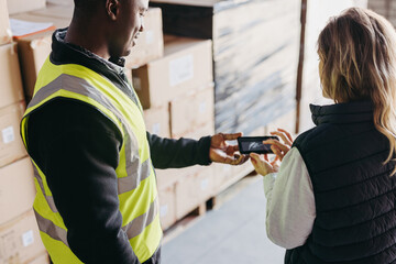 Warehouse worker e-signing a dock receipt after receiving a delivery
