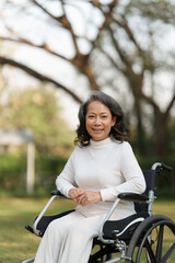 Fototapeta na wymiar Happy senior asian women in wheelchair at home garden