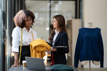 Multiethnic fashion designers working together in the studio.