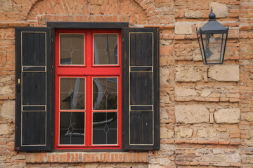 vintage wooden window on the ancient facade. old lantern on the wall