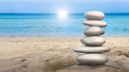 Balanced stones standing on the beach sand. 3D illustration