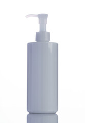 Plastic bottle with soap or shampoo reflected on white background