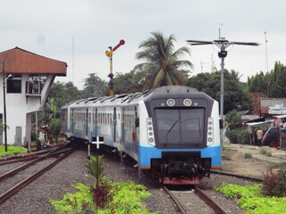 A train departs from a station after being given a clear signal. The signal is still a semaphore...