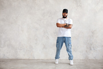 Full length portrait Hispanic man stands arms crossed, in casual wear jeans and white mockup...