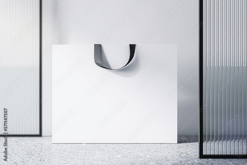 Poster front view on blank white paper shopping bag with place for your brand name or text on light concret