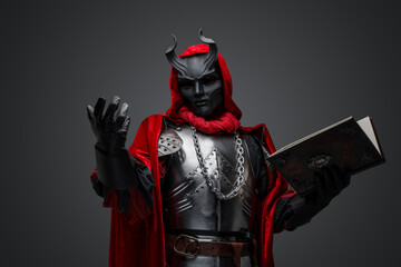 Portrait of evil knight with book dressed in red robe and plate armor.