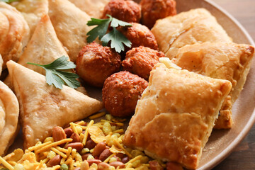 Snack platter including samoosas, pies, and crackles or chevra. South African celebration food