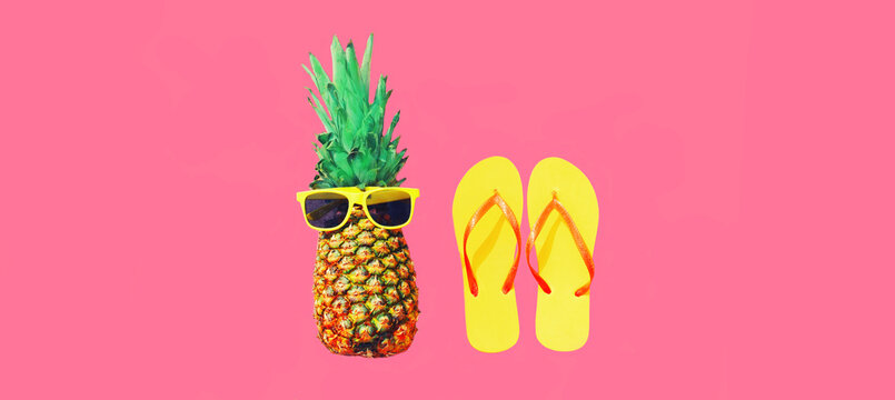 Summer vacation image, stylish pineapple and yellow flip flops on pink background