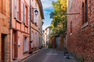 Fototapeta na wymiar Small narrow street in the town of Rabastens, in Tarn, Occitanie, France