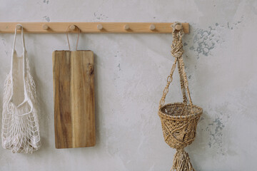 Eco-friendly market bag, wooden 
breadboard hanging on the wall in the kitchen. 