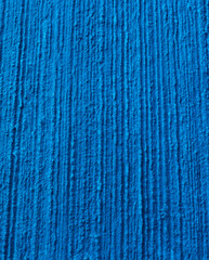 Texture of a plastered wall painted in blue. Concept background.