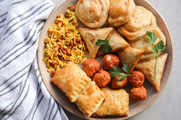 Snack platter including samoosas, pies, and crackles or chevra. South African celebration food