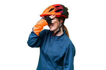 Young cyclist woman over isolated chroma key background covering eyes by hands and smiling - obrazy, fototapety, plakaty
