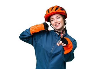 Young cyclist woman over isolated chroma key background making phone gesture and pointing front - obrazy, fototapety, plakaty