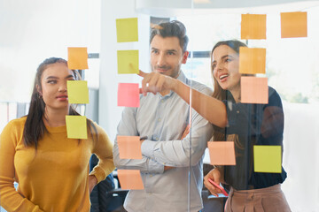 Businesswoman conducting brainstorming session with colleagues at office