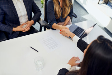 Candidate doing handshake with recruiter after interview at office
