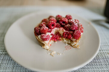 Delicious raspberry cake on plate on table