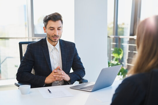 Recruiter talking to candidate in interview at office