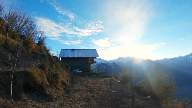 4K shot of a wooden cabin in the mountains of the Manali during the sunrise at Himachal Pradesh, India. Traditional local hut on the mountain during the morning. Wooden cabin on the slope of mountain.