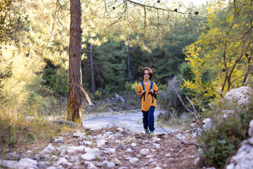 Fototapeta premium child is traveling. boy with a backpack on a hike.