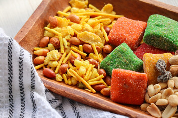 Snack bowl including peanuts and raisins, fruit dainties and crackles. Mebos and slangetjies