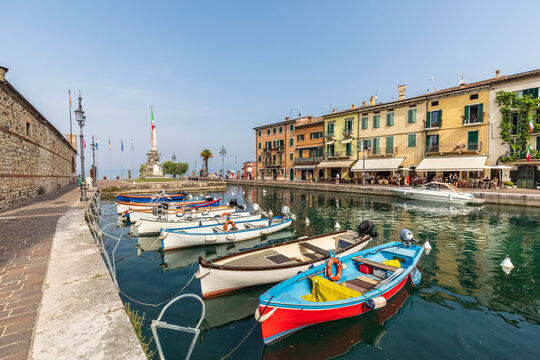 Italy, Veneto, Lazise, Boats moored on shore of Lake Garda