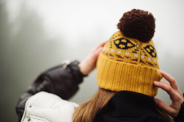 woman standing by forest in foggy weather