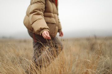 Unrecognizable female hands in autumn grass