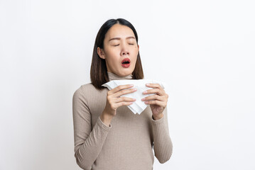 Portrait of beautiful young asian sick woman over isolated white background being wrapped in scarf sneezing, suffering from runny nose and high temperature. Cold and fever concept.