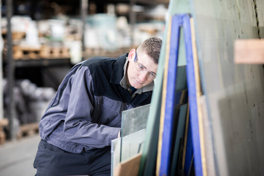 technician male working in a store checking a glass plate