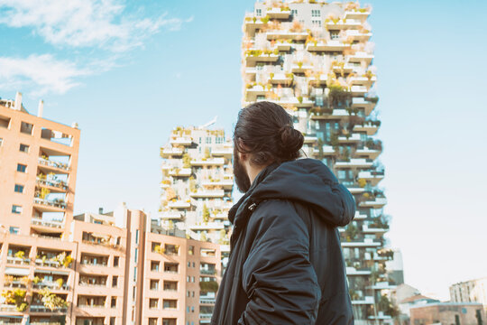 portrait of man looking towards bosco verticale in sunny winter