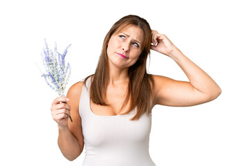 Middle age caucasian woman holding lavender over isolated background having doubts and with confuse...