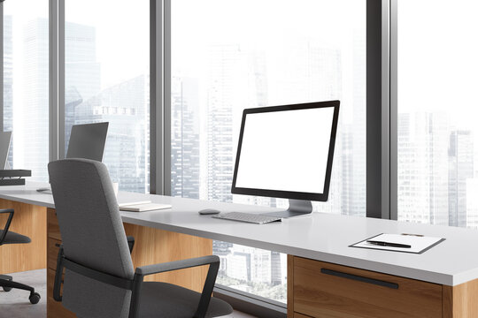 Business interior with pc desktop on table with mockup display, panoramic window
