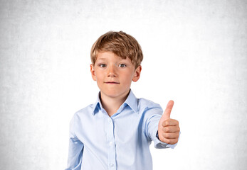 Confident handsome boy wearing formal wear standing showing thum