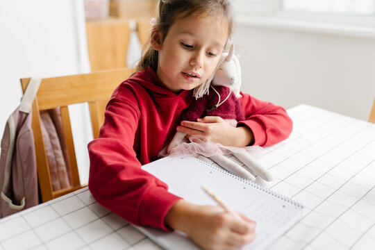 Girl doing mathematics homework at home