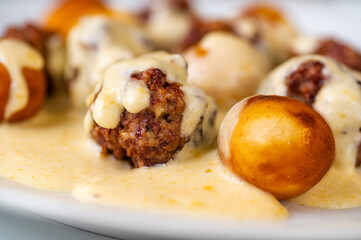 Baked meatball with fried croquette in lemon sauce.