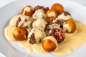 Meatball with fried croquette in lemon sauce,