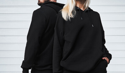 Design mock-up for clothing logo. Man and woman wear a basic hoodie. No logo street wear brand...