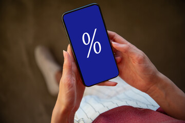 Cashback from a mobile phone, hand holds the phone on the phone screen percentage