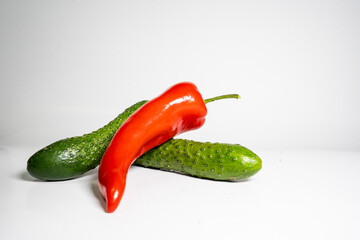 Fresh Cucumber and red pepper isolated on white background tasty and healthy food flat side view