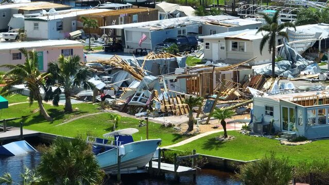 Severely damaged houses after hurricane Ian in Florida mobile home residential area. Consequences of natural disaster