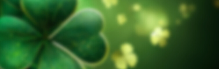 St Patrick day blurred background. Abstract green background decorated with shamrock leaves.