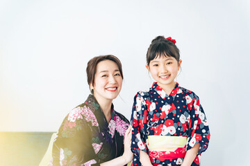女の子に浴衣を着せる女性