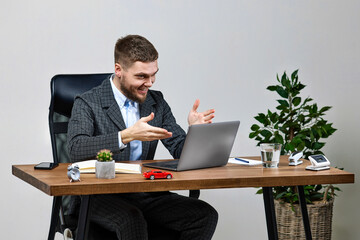 man sitting on chair at table and resting, using laptop