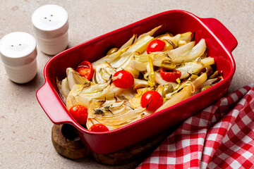 Baked fennel with tomato, olives, leek. Red casserole.