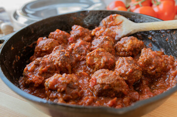Meatballs with tomato sauce in a cast iron pan