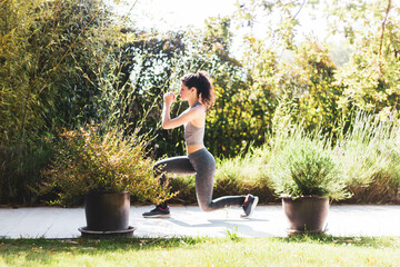 young woman exercising in her home garden