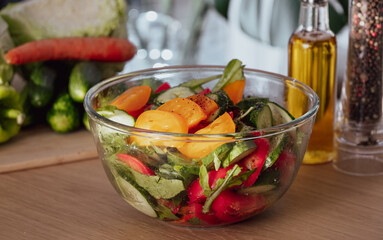 Salad. Vegetable Fresh Salad with Tomatoes, Cucumbers, Scallion and Olive Oil. Healthy Food. Vegetarian Diet. Making vegetable salad in the kitchen at home, Cutting Vegetables close-up
