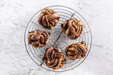 Freshly baked, caramel-cinnamon buns on the kitchen grill - Top of view