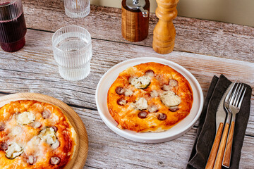 homemade pizza with sausages, cheese and vegetables